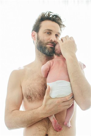 Mid adult man with newborn baby Stock Photo - Premium Royalty-Free, Code: 6102-08120641