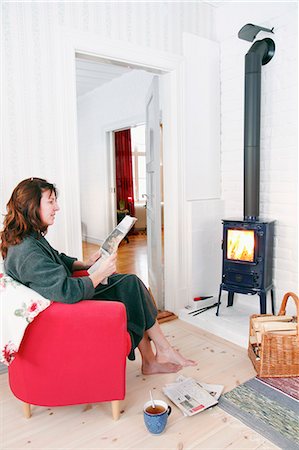 Woman in front of fireplace Stock Photo - Premium Royalty-Free, Code: 6102-08120736