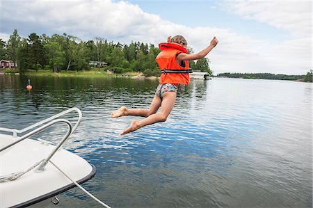 simsearch:6102-08001381,k - Girl jumping into water Stock Photo - Premium Royalty-Free, Code: 6102-08120915