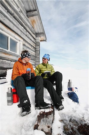 simsearch:6102-08520961,k - Couple resting in front of mountain cabin Stock Photo - Premium Royalty-Free, Code: 6102-08270536