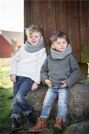 sweden blond boy - Boys standing in front of wooden house Stock Photo - Premium Royalty-Free, Code: 6102-08270734