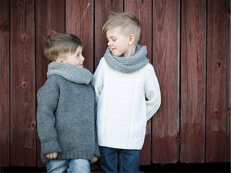 sweden blond boy - Smiling boys together in front of wooden house Stock Photo - Premium Royalty-Free, Code: 6102-08270735