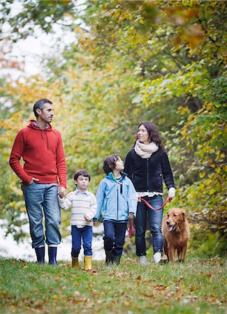 Family with dog walking through forest Stock Photo - Premium Royalty-Free, Code: 6102-08270945