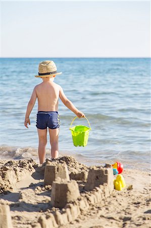 Boy on beach making sandcastles Stock Photo - Premium Royalty-Free, Code: 6102-08270967