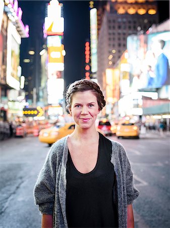 Portrait of smiling woman, Times Square, New York City, USA Stock Photo - Premium Royalty-Free, Code: 6102-08271173