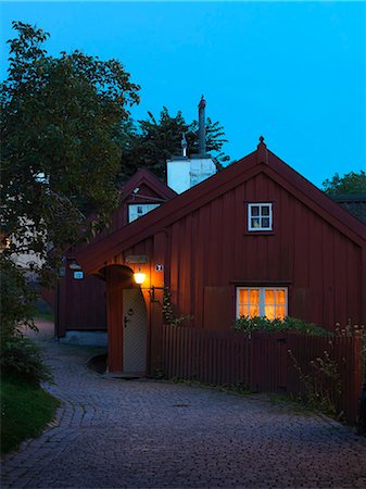 Illuminated wooden house at dusk Stock Photo - Premium Royalty-Free, Code: 6102-08271765