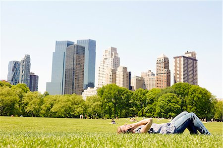 Woman in Central Park with Manhattan skyline, New York City, USA Stock Photo - Premium Royalty-Free, Code: 6102-08271723