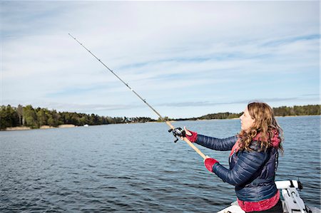 simsearch:6102-08001381,k - Young woman fishing Stock Photo - Premium Royalty-Free, Code: 6102-08278754