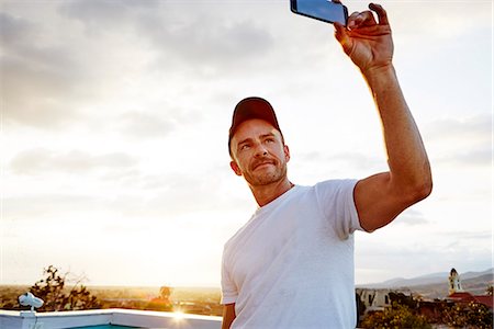 Man taking selfie Stock Photo - Premium Royalty-Free, Code: 6102-08384257