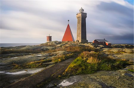 Lighthouse on rocky coast Stock Photo - Premium Royalty-Free, Code: 6102-08384294