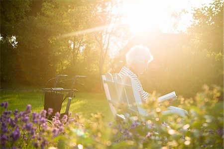 Senior woman reading book in garden Stock Photo - Premium Royalty-Free, Code: 6102-08384228