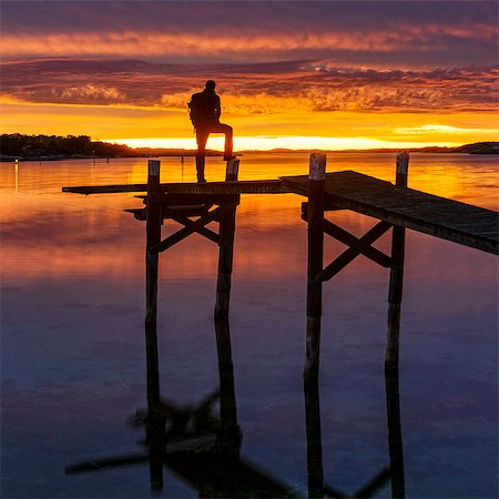 Silhouette of person looking at sunset Stock Photo - Premium Royalty-Free, Code: 6102-08384441