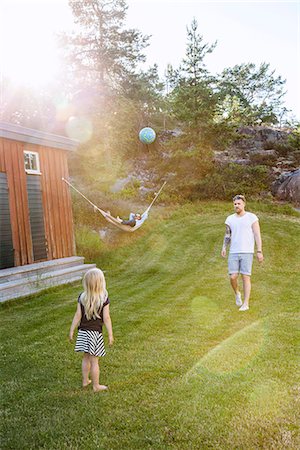 friends playing football - Father with daughter playing in garden Stock Photo - Premium Royalty-Free, Code: 6102-08384423