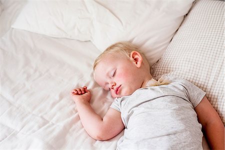 simsearch:6102-08168912,k - Small boy slipping in bed Photographie de stock - Premium Libres de Droits, Code: 6102-08384565