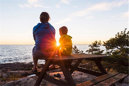 people relaxing on a lake'' - Mother with son at sunset Stock Photo - Premium Royalty-Free, Code: 6102-08388395