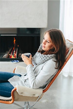 simsearch:6102-08000621,k - Woman drinking coffee in front of fireplace Stock Photo - Premium Royalty-Free, Code: 6102-08329974