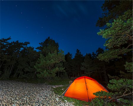 pebbles in the lake - Orange tent in forest at night Stock Photo - Premium Royalty-Free, Code: 6102-08481313