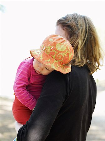 simsearch:6102-08566788,k - Mother carrying tired daughter Stock Photo - Premium Royalty-Free, Code: 6102-08558808