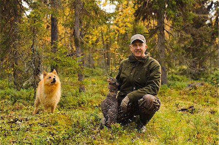 Man with dog and dead Common Pheasant Stock Photo - Premium Royalty-Free, Code: 6102-08558831