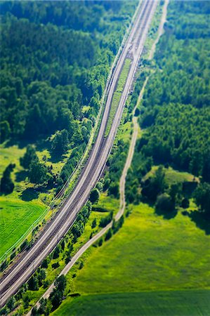 simsearch:6102-06026084,k - Aerial view of rural scene with road and railroad track Stock Photo - Premium Royalty-Free, Code: 6102-08558832