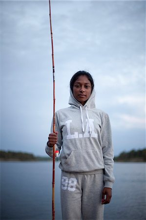 simsearch:6102-08001381,k - Young woman with fishing rod at evening Stock Photo - Premium Royalty-Free, Code: 6102-08559159
