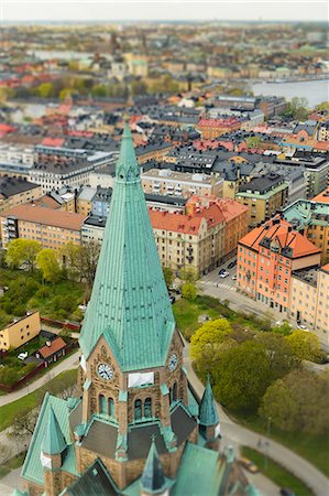 Church tower with city buildings in background Stock Photo - Premium Royalty-Free, Code: 6102-08559107