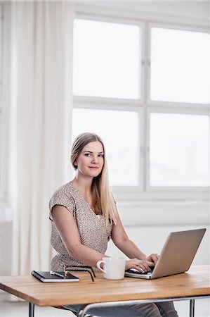 Young woman using laptop Stock Photo - Premium Royalty-Free, Code: 6102-08566667