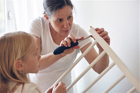 Mother and daughter building cot Stock Photo - Premium Royalty-Free, Code: 6102-08566783