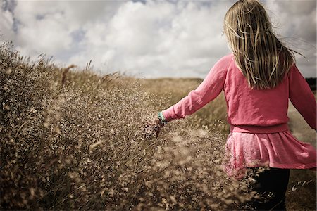 Girl walking on meadow Stock Photo - Premium Royalty-Free, Code: 6102-08521165