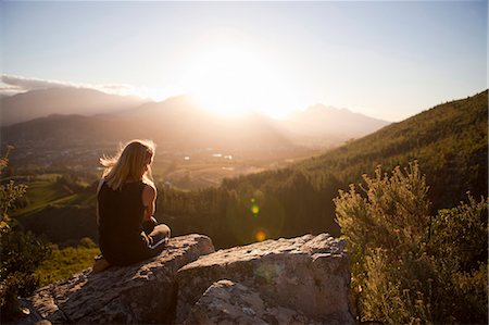 simsearch:6102-08000621,k - Woman sitting on mountain and looking at sunset Stock Photo - Premium Royalty-Free, Code: 6102-08746458