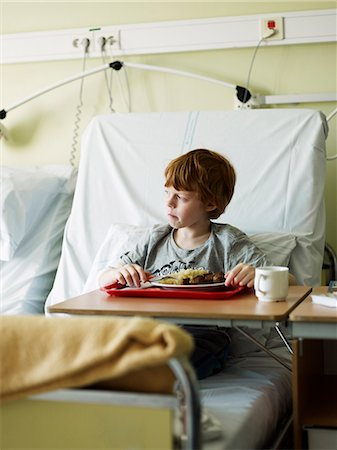 sad child sitting - Boy eating meal in hospital Stock Photo - Premium Royalty-Free, Code: 6102-08746595