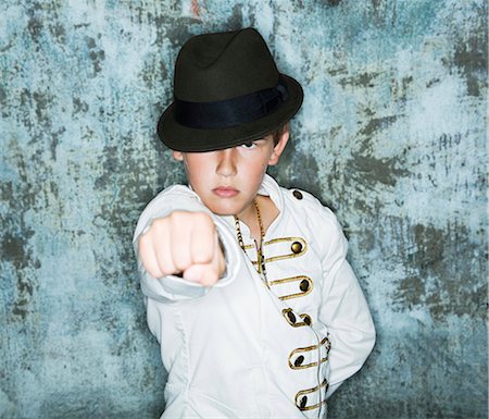 Portrait of boys in hat showing fist Stock Photo - Premium Royalty-Free, Code: 6102-08748561
