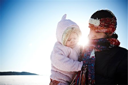 simsearch:6102-06337107,k - Mother with baby daughter in the winter's sun, Sweden. Photographie de stock - Premium Libres de Droits, Code: 6102-08748818