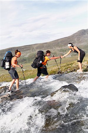 simsearch:6102-07844212,k - Hikers crossing mountain river Stock Photo - Premium Royalty-Free, Code: 6102-08760399