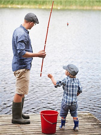 Father with son fishing on jetty Stock Photo - Premium Royalty-Free, Code: 6102-08760488