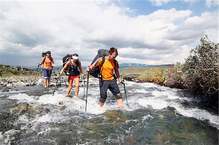 simsearch:6102-07844212,k - Hikers crossing mountain river Stock Photo - Premium Royalty-Free, Code: 6102-08760400