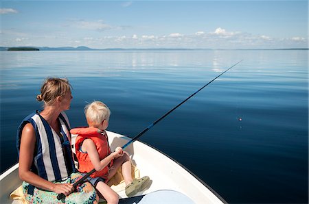 simsearch:6102-08001381,k - Mother with son fishing on boat Stock Photo - Premium Royalty-Free, Code: 6102-08760560