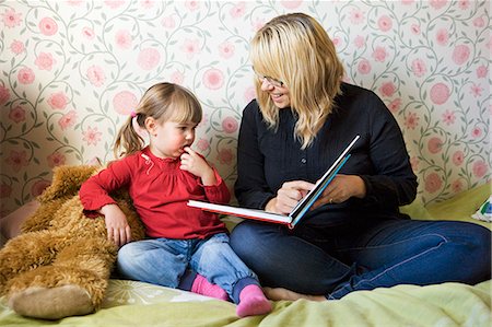 simsearch:6102-08566788,k - Mother reading book to her daughter Stock Photo - Premium Royalty-Free, Code: 6102-08760771