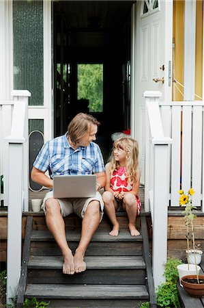 stairs children - Father with daughter sitting on steps in front of house with laptop, Sollentuna, Stockholm, Sweden Stock Photo - Premium Royalty-Free, Code: 6102-08761151