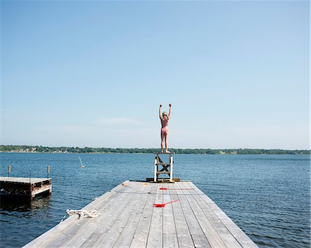 preteen bikini - A girl diving from a jetty Stock Photo - Premium Royalty-Free, Code: 6102-08761295