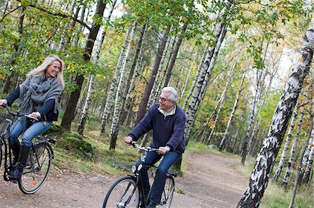 Senior couple cycling in forest, Delsjon, Gothenburg, Sweden Stock Photo - Premium Royalty-Free, Code: 6102-08761217