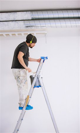 simsearch:6102-07158067,k - Painter on ladder wearing headphones, Sweden Stock Photo - Premium Royalty-Free, Code: 6102-08761394