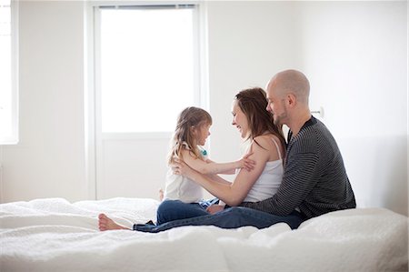 simsearch:6102-08566788,k - Happy family on bed Stock Photo - Premium Royalty-Free, Code: 6102-08881663