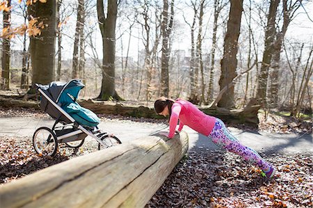 single mom - Woman exercising in forest Stock Photo - Premium Royalty-Free, Code: 6102-08881607