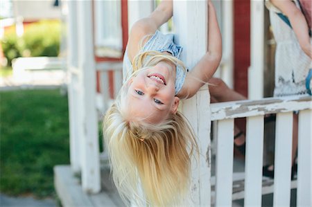 person upside down - Happy girl looking at camera Stock Photo - Premium Royalty-Free, Code: 6102-08881762