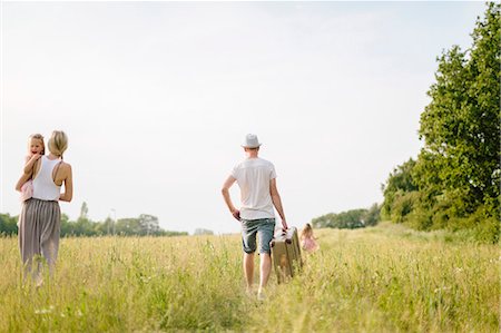 simsearch:6102-08542382,k - Family walking in meadow Stock Photo - Premium Royalty-Free, Code: 6102-08881809