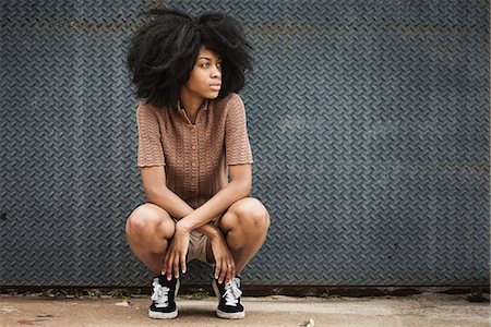 Young woman with afro hair Stock Photo - Premium Royalty-Free, Code: 6102-08885358