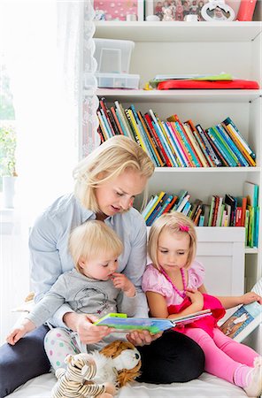 simsearch:6102-08566788,k - Mother reading book to her daughters Stock Photo - Premium Royalty-Free, Code: 6102-08885613