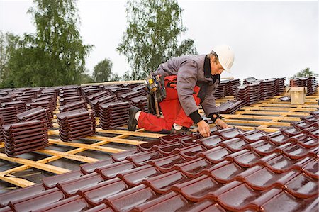 simsearch:6102-07158067,k - A young man roofing, Sweden. Stock Photo - Premium Royalty-Free, Code: 6102-08800621