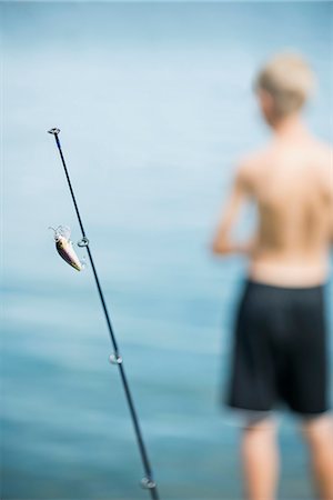 simsearch:6102-08001381,k - Fishing rod and boy in background Stock Photo - Premium Royalty-Free, Code: 6102-08942546